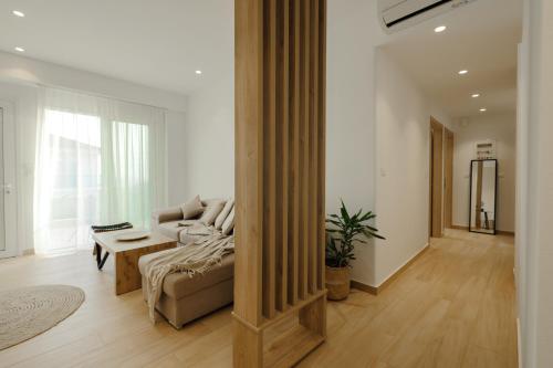 a living room with a couch and a table at Casa Costa Suites Plus in Kanali