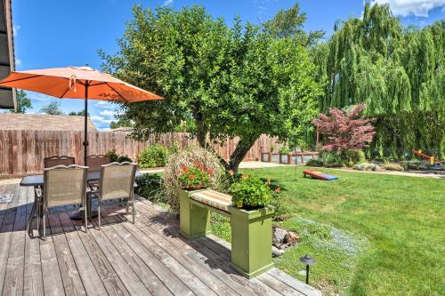 a patio with an umbrella and a table and chairs at Central Medford Family Retreat with Large Yard! in Medford