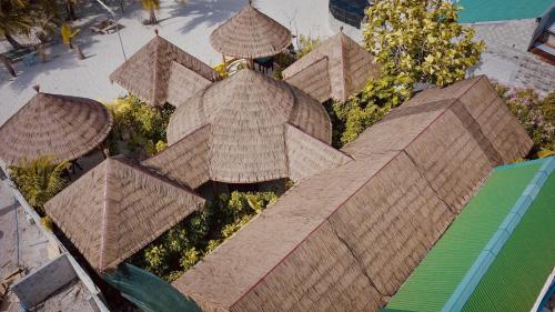 an overhead view of a building with straw roofs at Sabba Beach Suite , Fodhdhoo - Maldives in Velidhoo