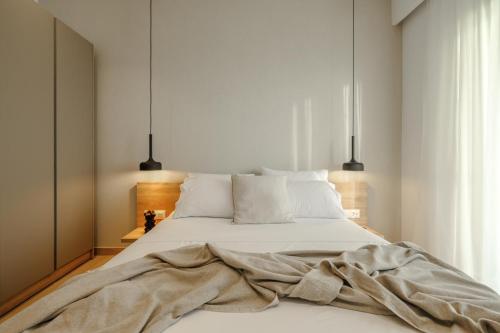 a bedroom with a bed with a blanket on it at Casa Costa Suites Plus in Kanali