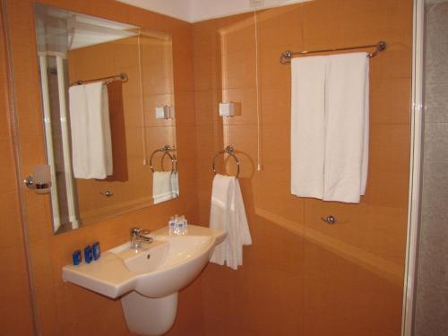a bathroom with a sink and a mirror at Blue Orange Beach Resort in Sozopol
