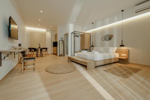 a large bedroom with a bed and a table at Casa Costa Suites Plus in Kanali