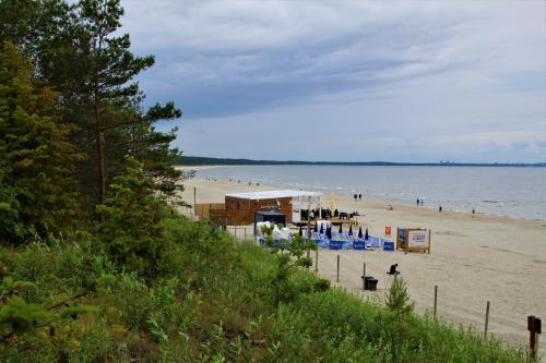 a beach with people on the sand and water at Prima Playa in Międzyzdroje