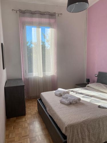 a bedroom with two beds and a window at Sweet Home Sara in Ovada