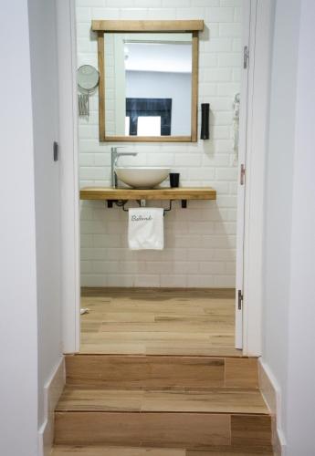 a bathroom with a sink and a mirror at Balhondo Open Village in Puebla de Alcocer
