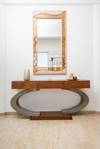 a mirror and a table in a room at Dene Hollow Oroklini in Voroklini
