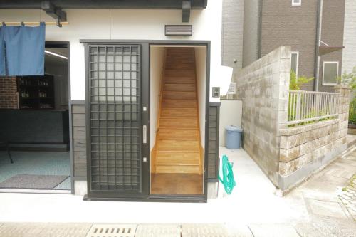 Watatsumi no yado - Vacation STAY 44120v في إكي: باب خشبي مع درج خشبي في مبنى