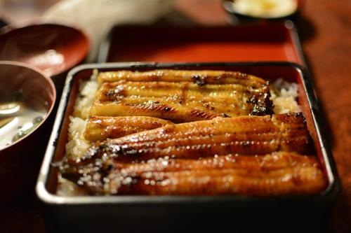 a tray of food with meat and rice on a table at Laffitte Hirai Condominium Hotel in Tokyo
