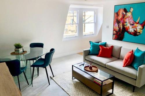 a living room with a couch and a table at Ideally located 2 bedroom luxury apartment in Bath