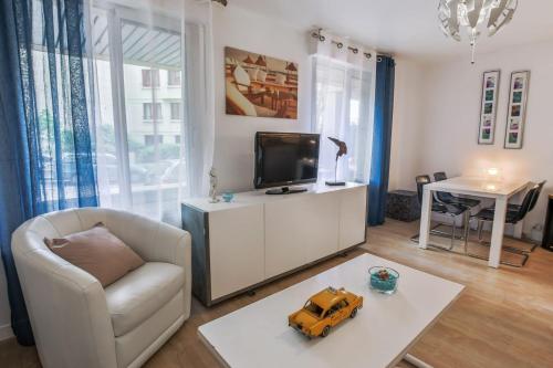 a living room with a tv and a toy truck on a table at Studio Faidherbe - Welkeys in Les Lilas
