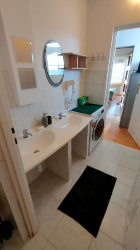 a bathroom with a sink and a washing machine at Rodzinne Siedlisko in Biskupiec