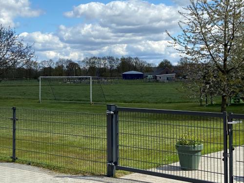 a fence with a soccer goal in a field at Veldzicht Brunsting in Beilen