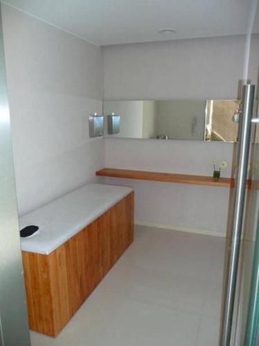 a small bathroom with a sink and a mirror at Quartier San Telmo Luxury Pool Gym & Spa, piscina climatizada in Buenos Aires