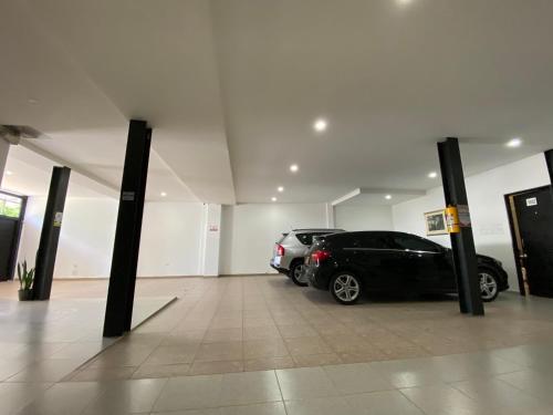 a garage with two cars parked in it at CasaBlanca ApartaEstudios in Girardot
