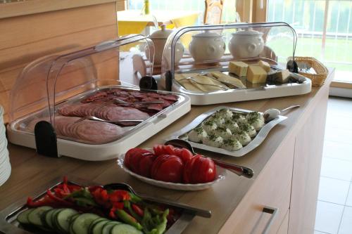 a buffet with meat and vegetables on a counter at Frühstückspension Seerose in Weissensee