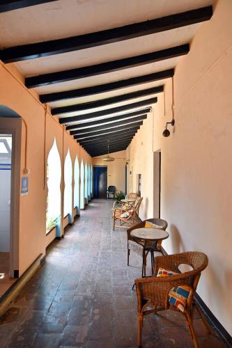 a hallway with tables and chairs in a building at Hostal l'Estrella in Palafrugell