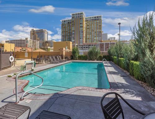 a swimming pool with chairs and a city in the background at WorldMark Reno in Reno