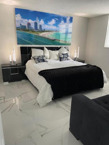 a bedroom with a large bed with a large painting on the wall at Ocean view Hollywood in Hollywood