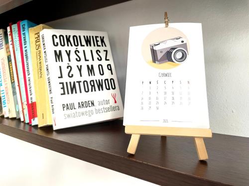 a calendar sitting on a shelf with books at STARE MIASTO in Olsztyn