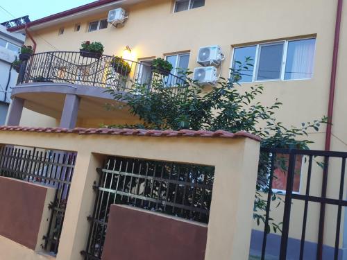 a building with a balcony with plants on it at DMS Family House in Eforie Sud