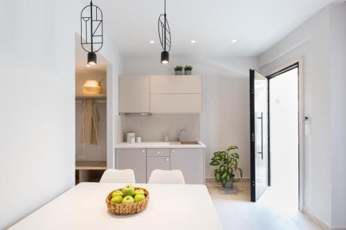 a kitchen with a table with a bowl of apples on it at Calmare suites in Rethymno Town