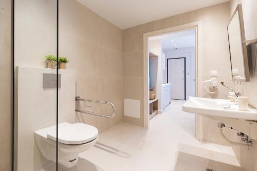 a bathroom with a toilet and a sink at Calmare suites in Rethymno Town