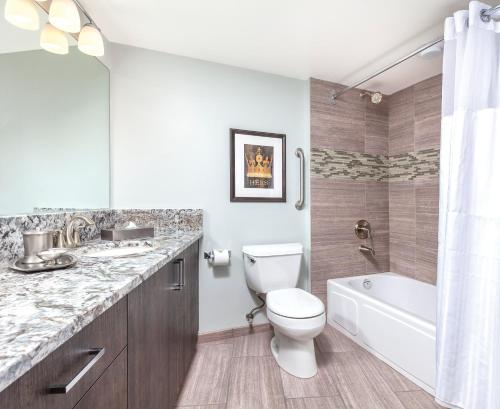 a bathroom with a toilet and a sink and a tub at WorldMark Victoria in Victoria