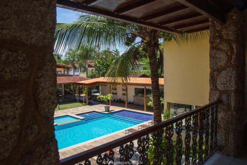 a view of the pool from the balcony of a villa at Pousada Eclipse Paraty in Paraty