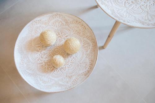 a white bowl with three balls on a table at Calmare suites in Rethymno Town