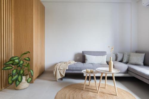 a living room with a couch and a table at Calmare suites in Rethymno Town