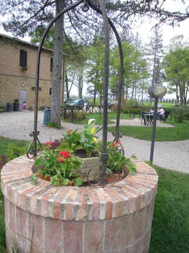 a flower garden in a brick planter in a park at Agriturismo San Galgano in Chiusdino