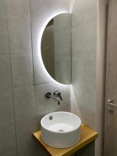 a bathroom with a white sink and a mirror at Green room in Marathopoli