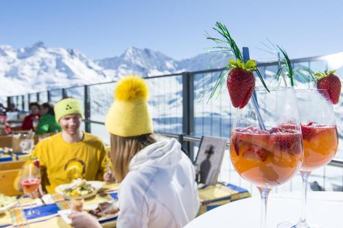 a man and a woman sitting at a table with food at Ferienwohnung Wallner in Wald am Arlberg