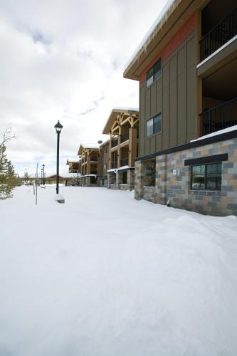 a snow covered parking lot in front of a building at WorldMark West Yellowstone in West Yellowstone