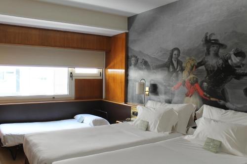 Ένα ή περισσότερα κρεβάτια σε δωμάτιο στο Hotel Goya