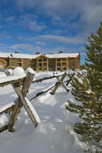 a lodge in the snow with a wooden fence at WorldMark West Yellowstone in West Yellowstone