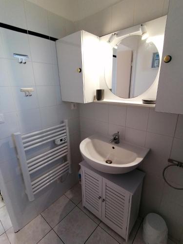 une salle de bain avec un lavabo et un miroir dans l'établissement La Catalane - Les Jardins du Rivage - wifi- piscine, au Barcarès