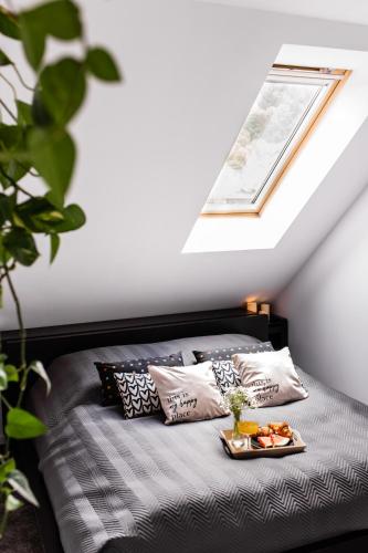 a bedroom with a bed with a tray of food on it at Apartament w centrum 3 in Ustrzyki Dolne