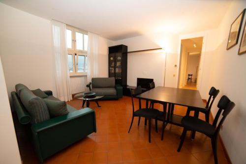 un soggiorno con tavolo e sedie di Little Marina Apartment a Malgrate