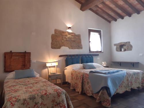En eller flere senger på et rom på Agriturismo Poggio Ridulfo