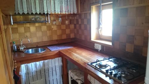 a small kitchen with a stove and a sink at Villa panoramica Gazzi in Arco