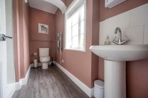 a bathroom with a sink and a toilet at The Teapot Cottage in town centre FREE parking in Stratford-upon-Avon