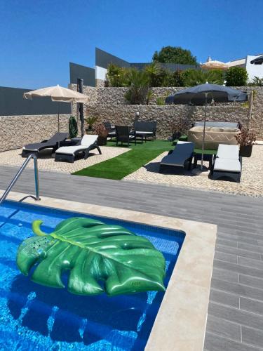 a swimming pool with a green turtle painted on it at Sunfield Guest House - Only Adults in Albufeira