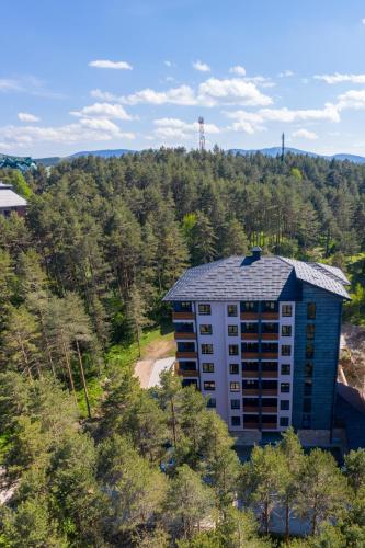 an aerial view of a building in the woods at Apartman CROWN Zlatibor Vila Leonardo 6 in Zlatibor