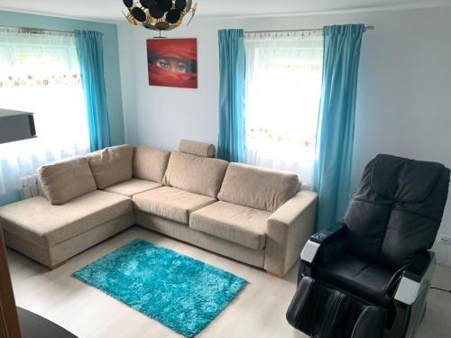 a living room with a couch and a chair at Villa Wiki w Górach in Kamesznica