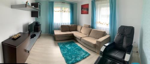 a living room with a couch and a chair at Villa Wiki w Górach in Kamesznica