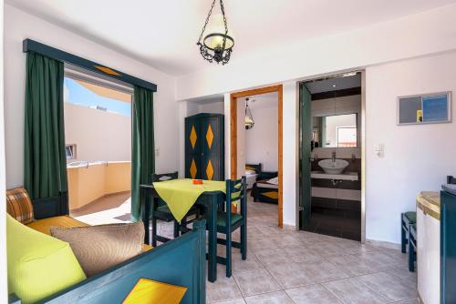 a living room with a table and a couch at Cirillo Family Hotel-Christinas Studios in Mastichari