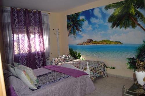 a bedroom with a mural of a beach at Villa la Masia in Miami Platja