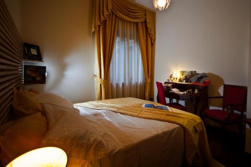 a bedroom with a bed and a window and a table at Napoli Porta Di Mare in Naples
