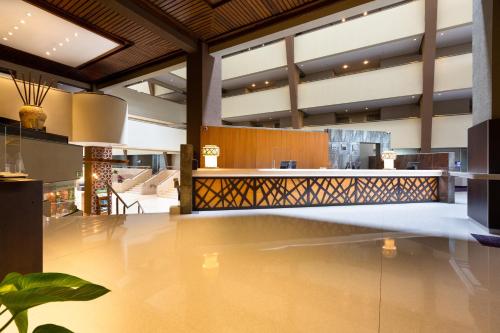 a lobby with a bar in a building at Crowne Plaza San Jose La Sabana by IHG in San José